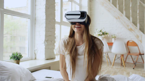 Young woman wearing vr headset and smiling