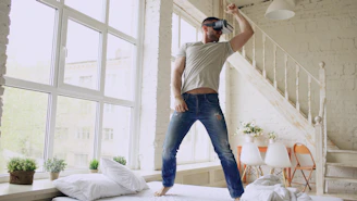 Man wearing vr headset dancing in bright room