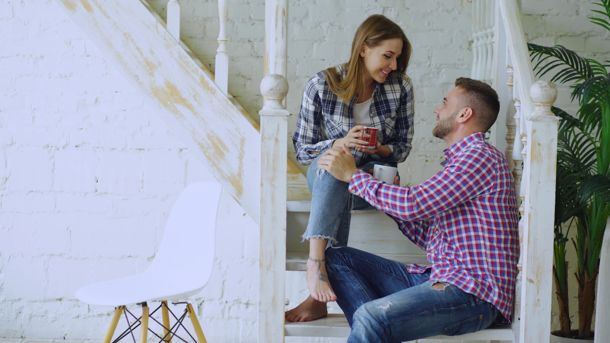 Smiling man and woman checking phone messages together and laughing during a date