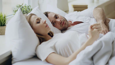 Couple lying in bed together