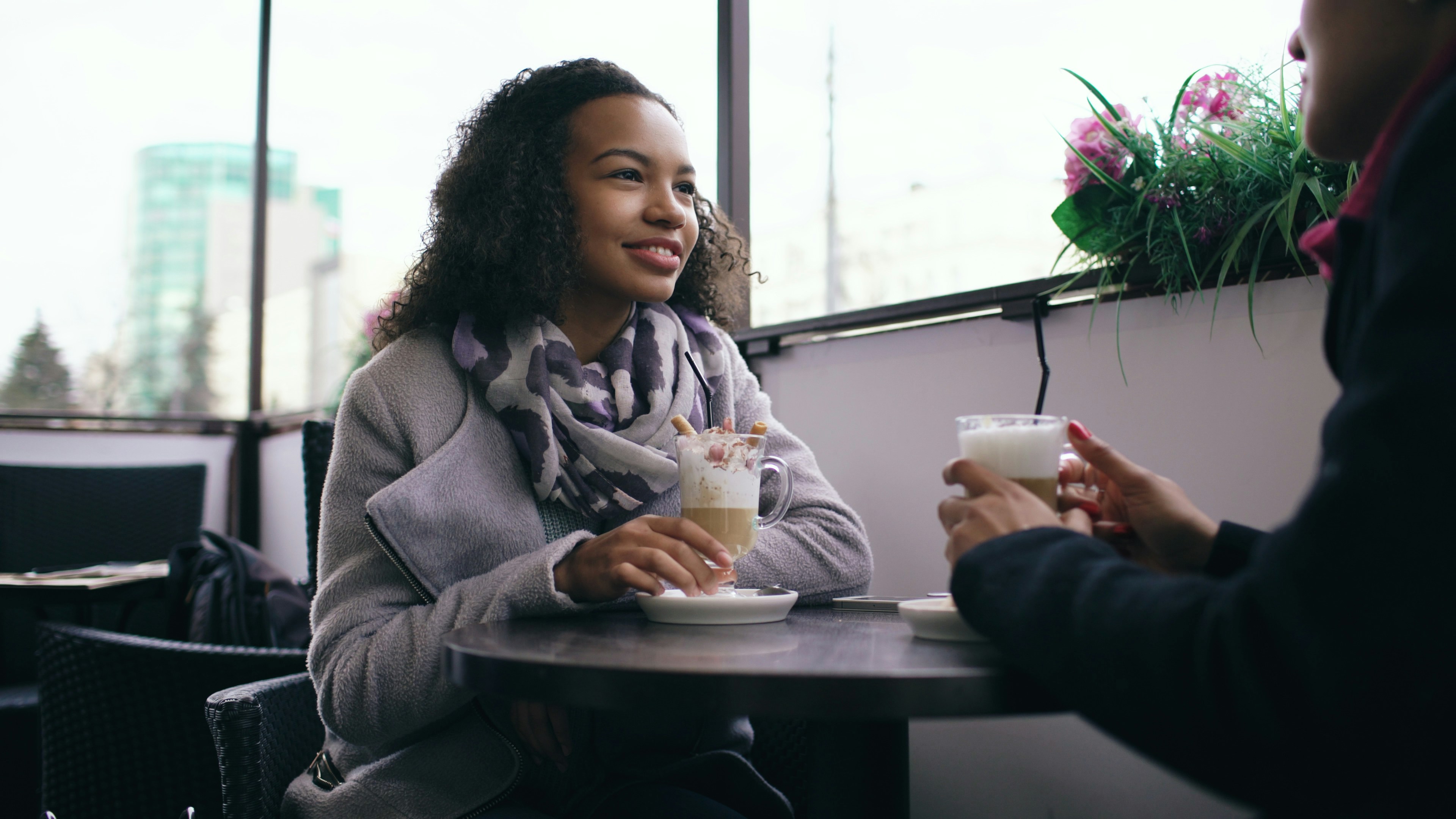 Two friends having a supportive conversation over coffee, demonstrating empathy and connection - help with depression and anxiety