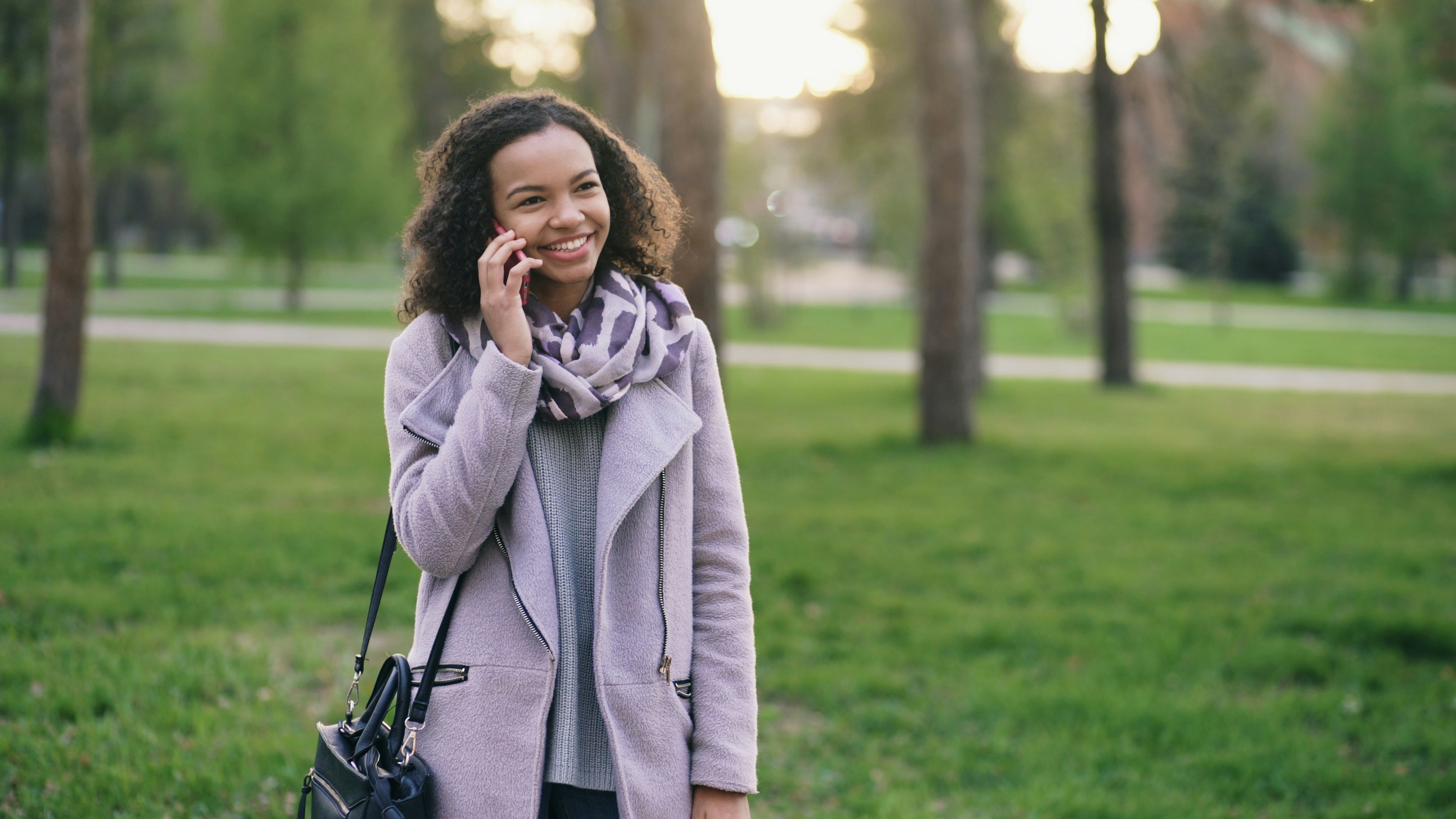 Woman talking on phone in a park