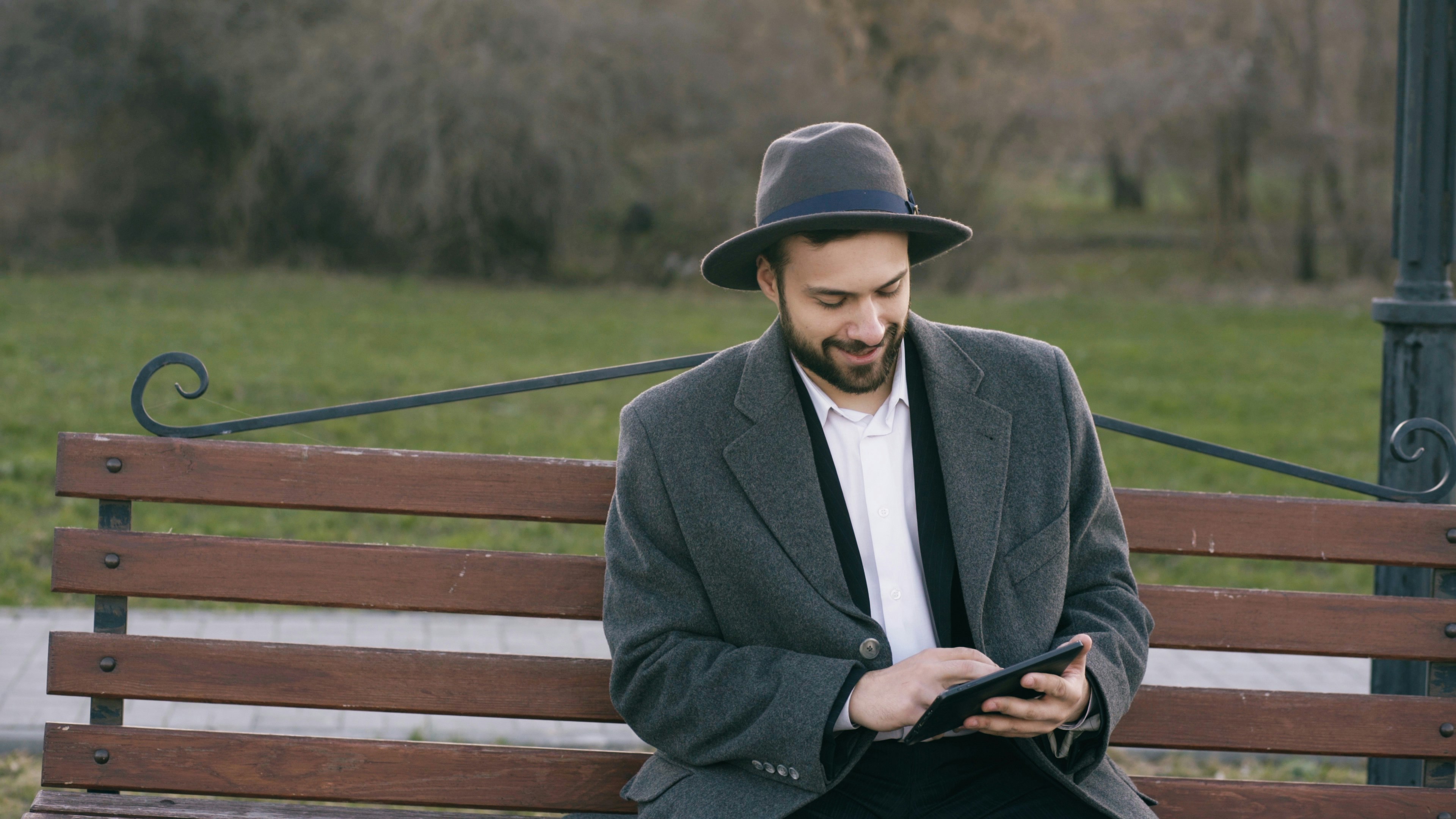 A smiling woman in a boutique using a tablet.