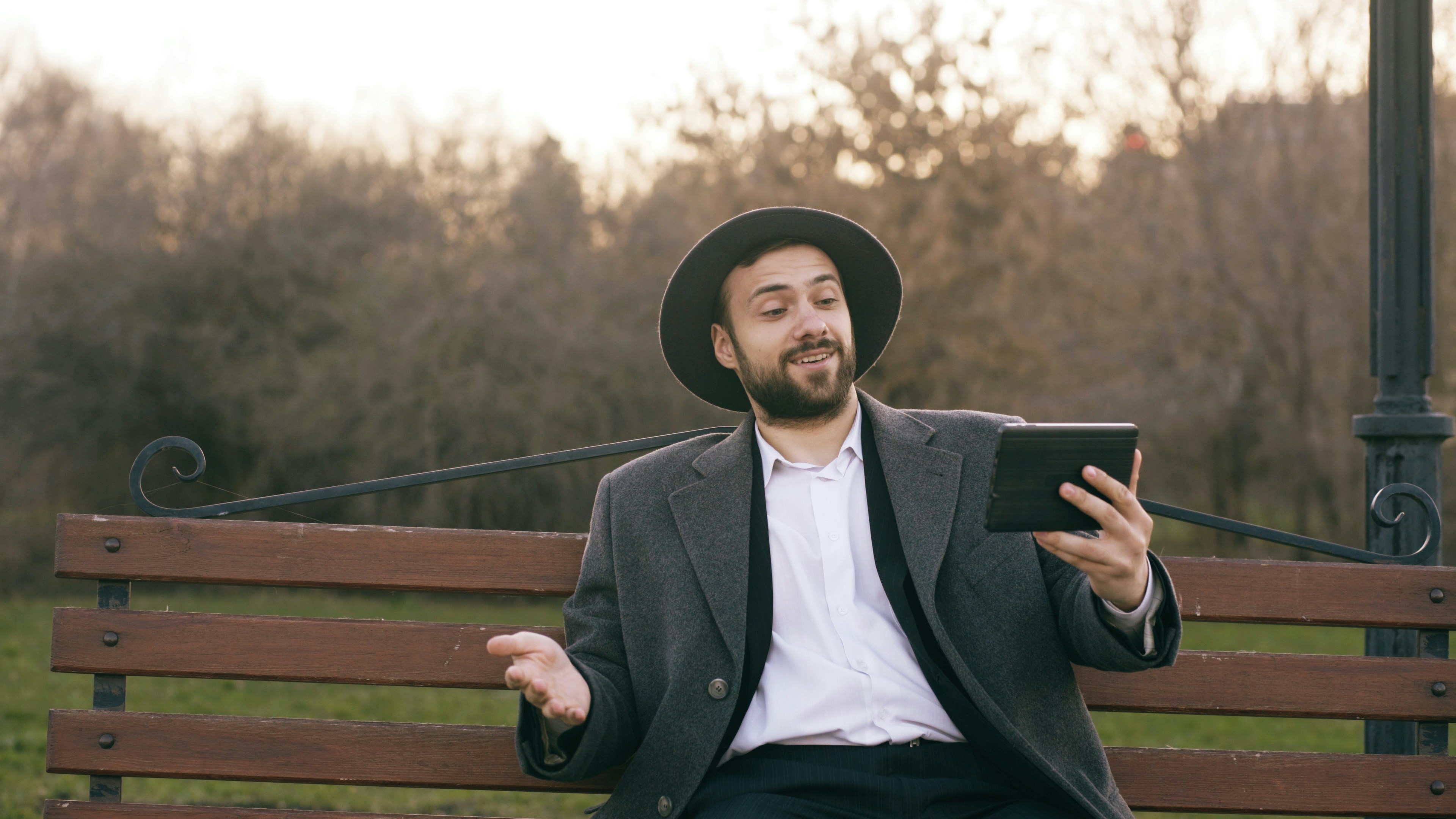 A man in a blue shirt handing documents over a desk.
