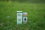 Herbal medicine bottle and box on grass