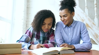 Two women studying together at a table.
