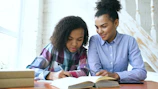 Two women studying together at a table.