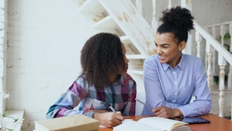 Mother and daughter studying together at a table.
