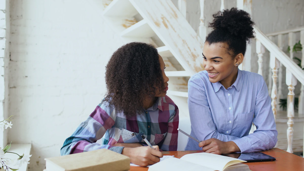 A woman and a teenage girl smiling as they work through a lesson together at a table