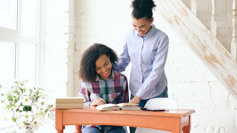 Adult working with a student at a desk in a school setting