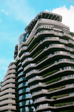 Modern apartment buildings with curved balconies and greenery