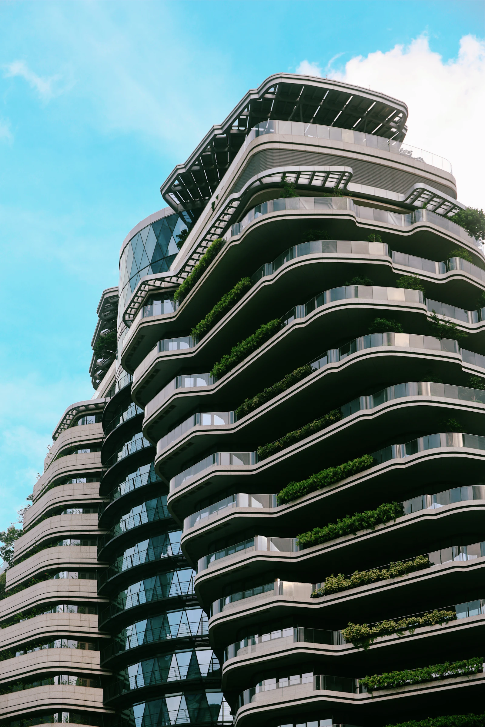 Modern residential towers with curved balconies and mature landscaping