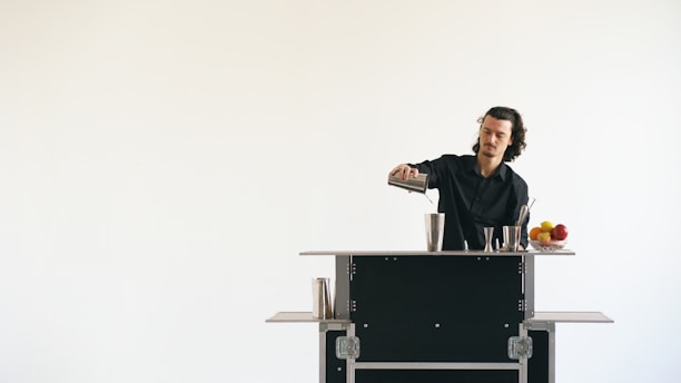 Bartender preparing a drink behind a bar