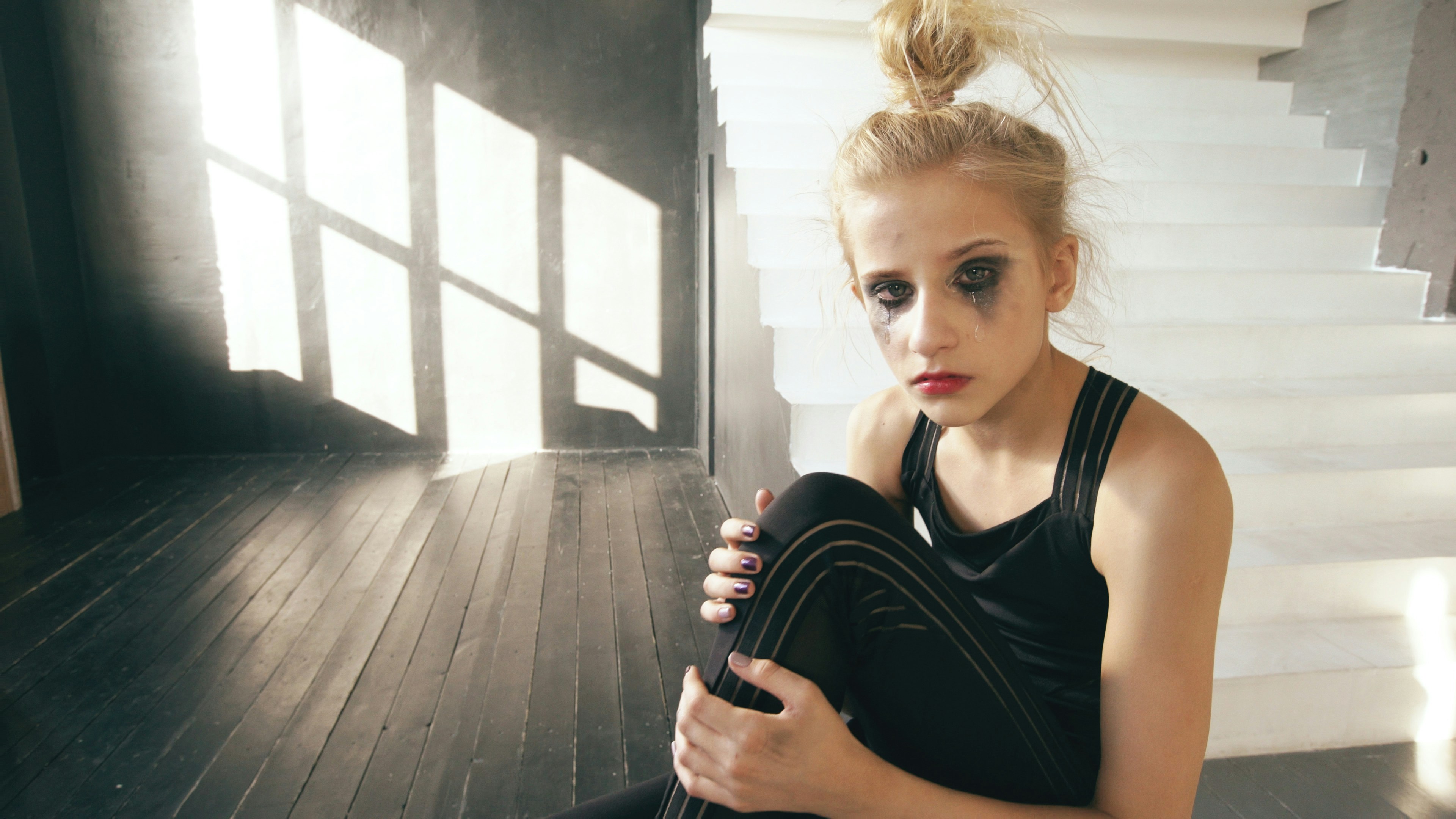 Teenager sitting alone in dance studio