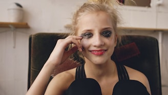 Young woman with smudged makeup smiles