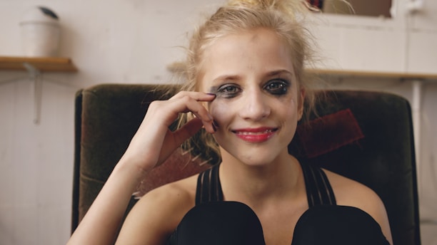 Young woman with smudged makeup smiles