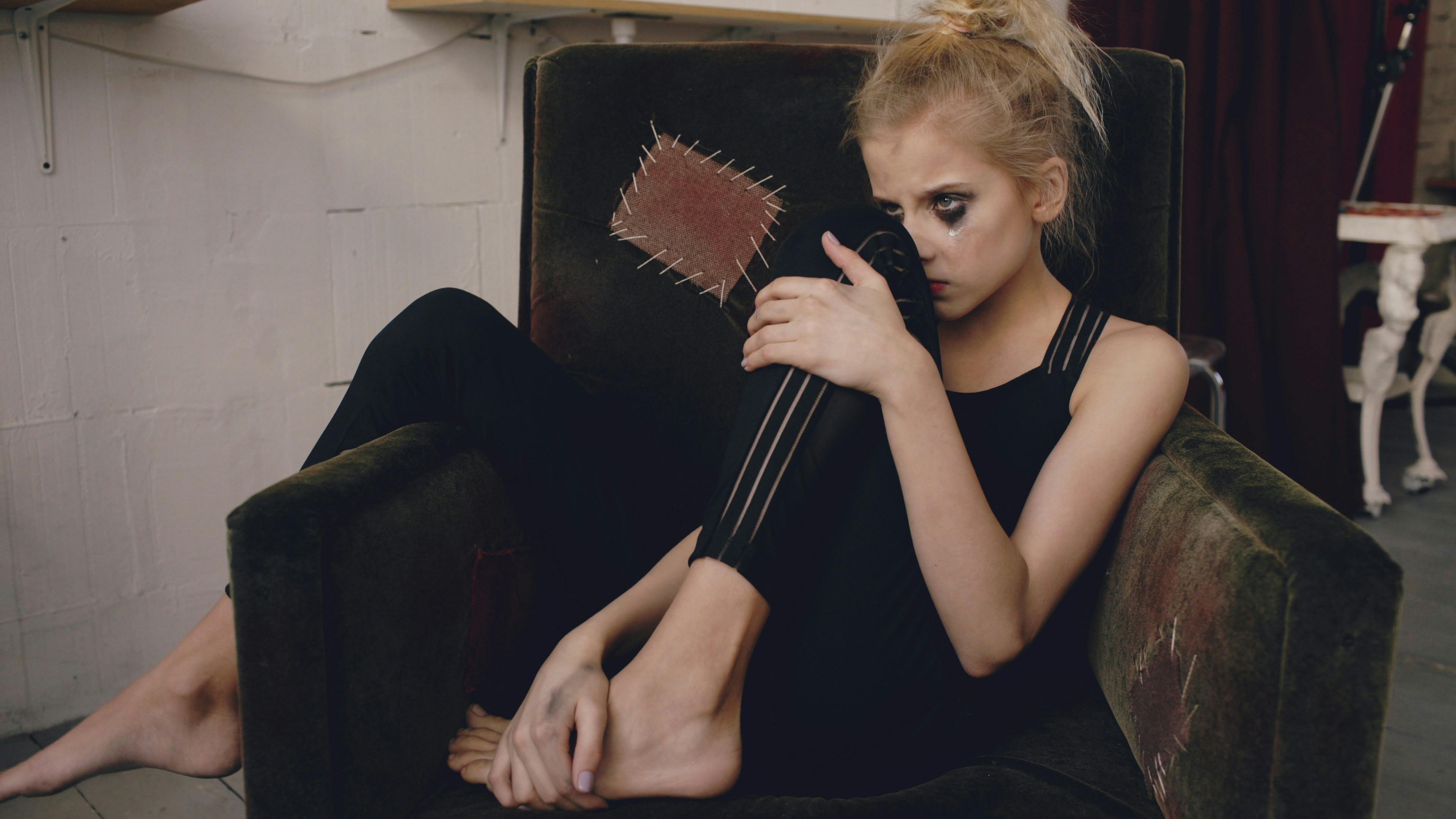 Teen actress with smudged makeup reflecting on failure