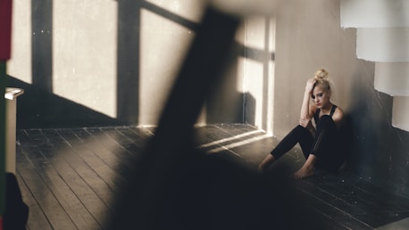 Woman sitting alone in a sunlit room