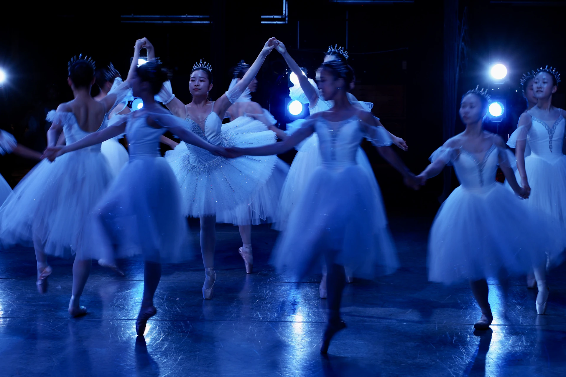 Ballerinas in white tutus performing on stage