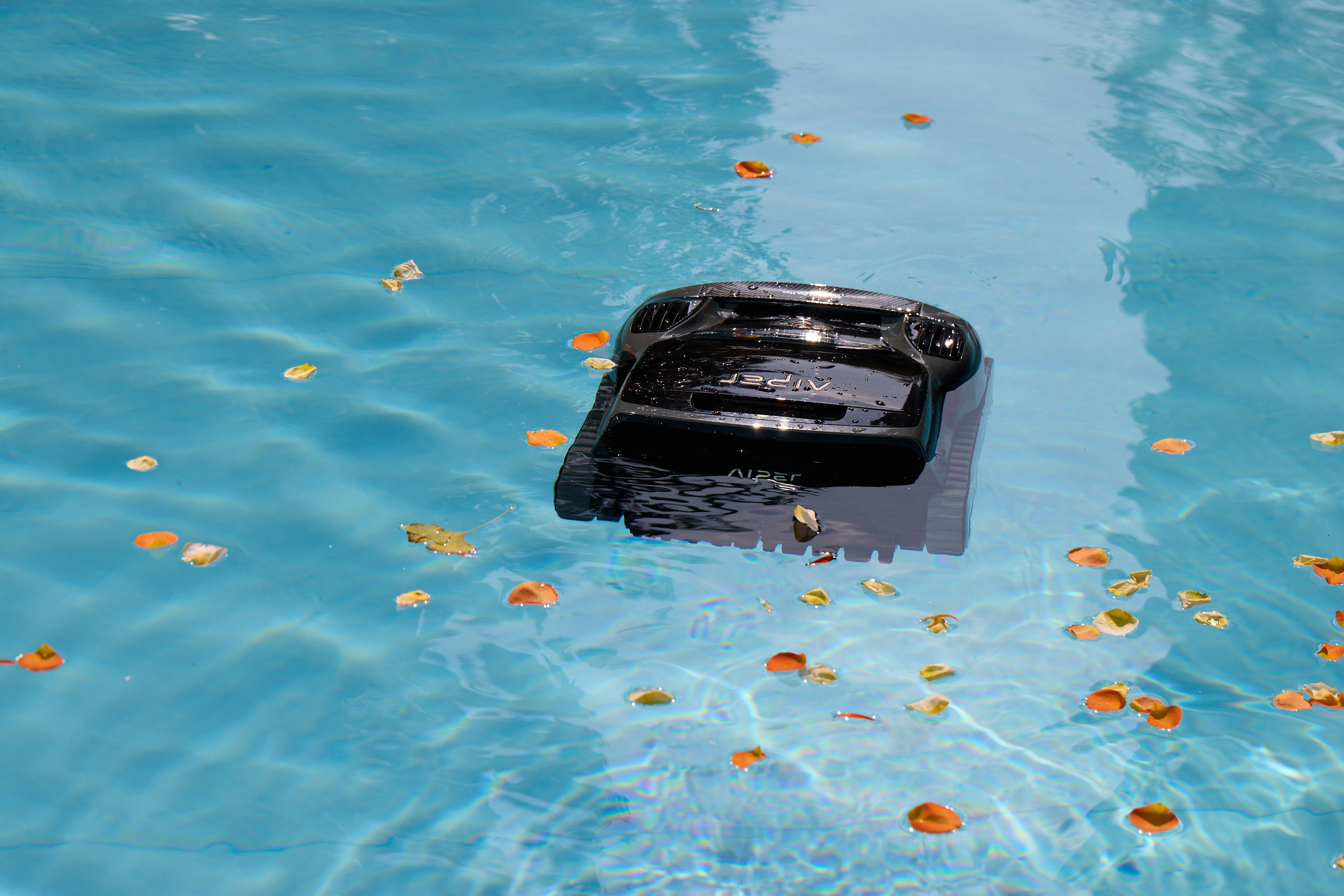 rugged portable bluetooth speaker floating in a swimming pool during sunset