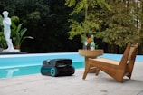 Robotic lawn mower by a swimming pool