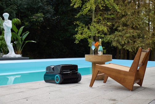 Robotic lawn mower by a swimming pool