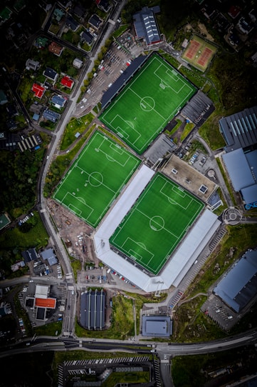 Aerial view of multiple green soccer fields.