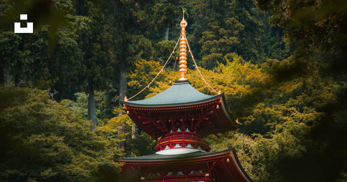 Red pagoda temple nestled among lush green trees photo – Free Building ...