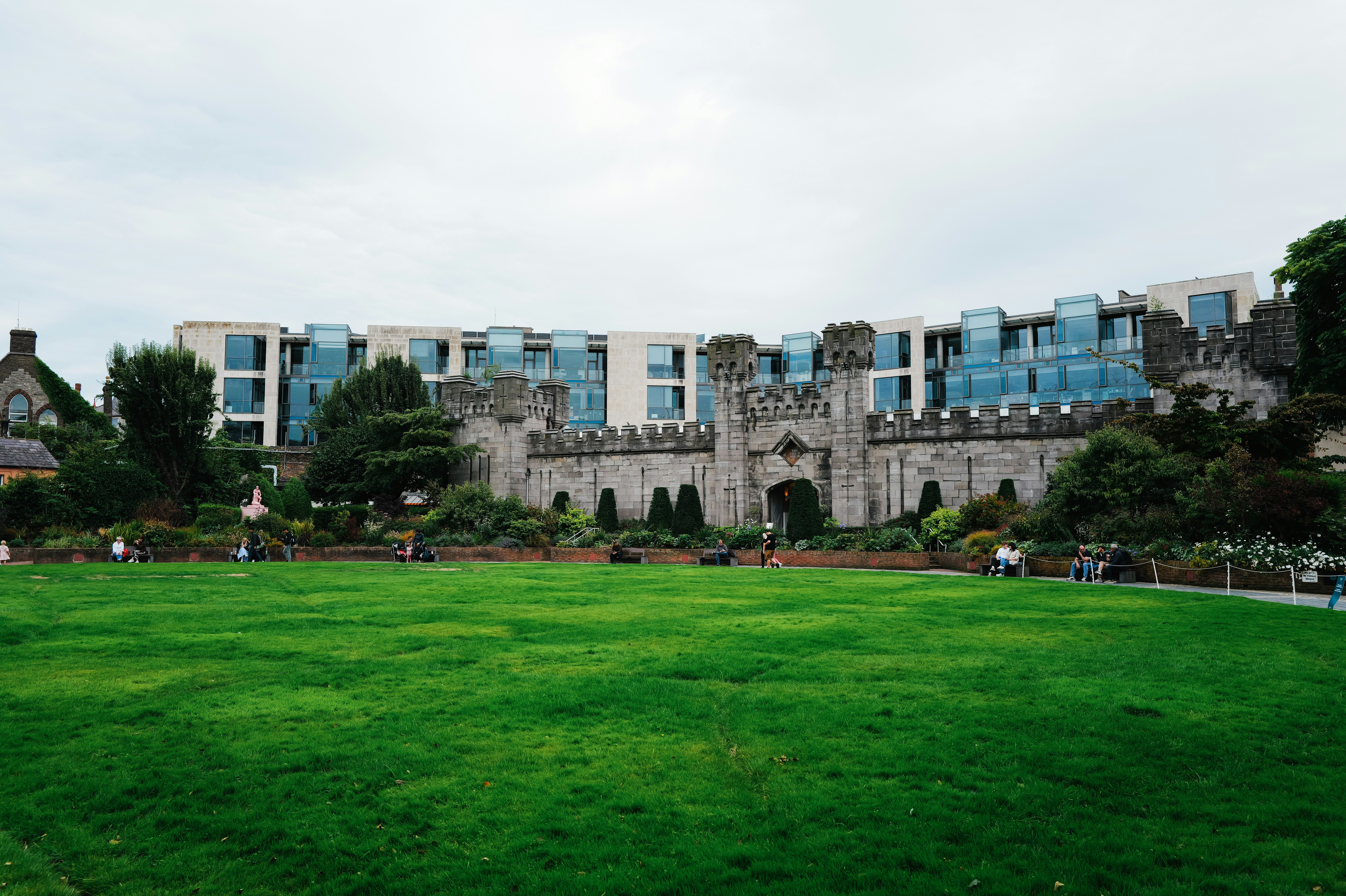 Historic castle walls with modern building behind