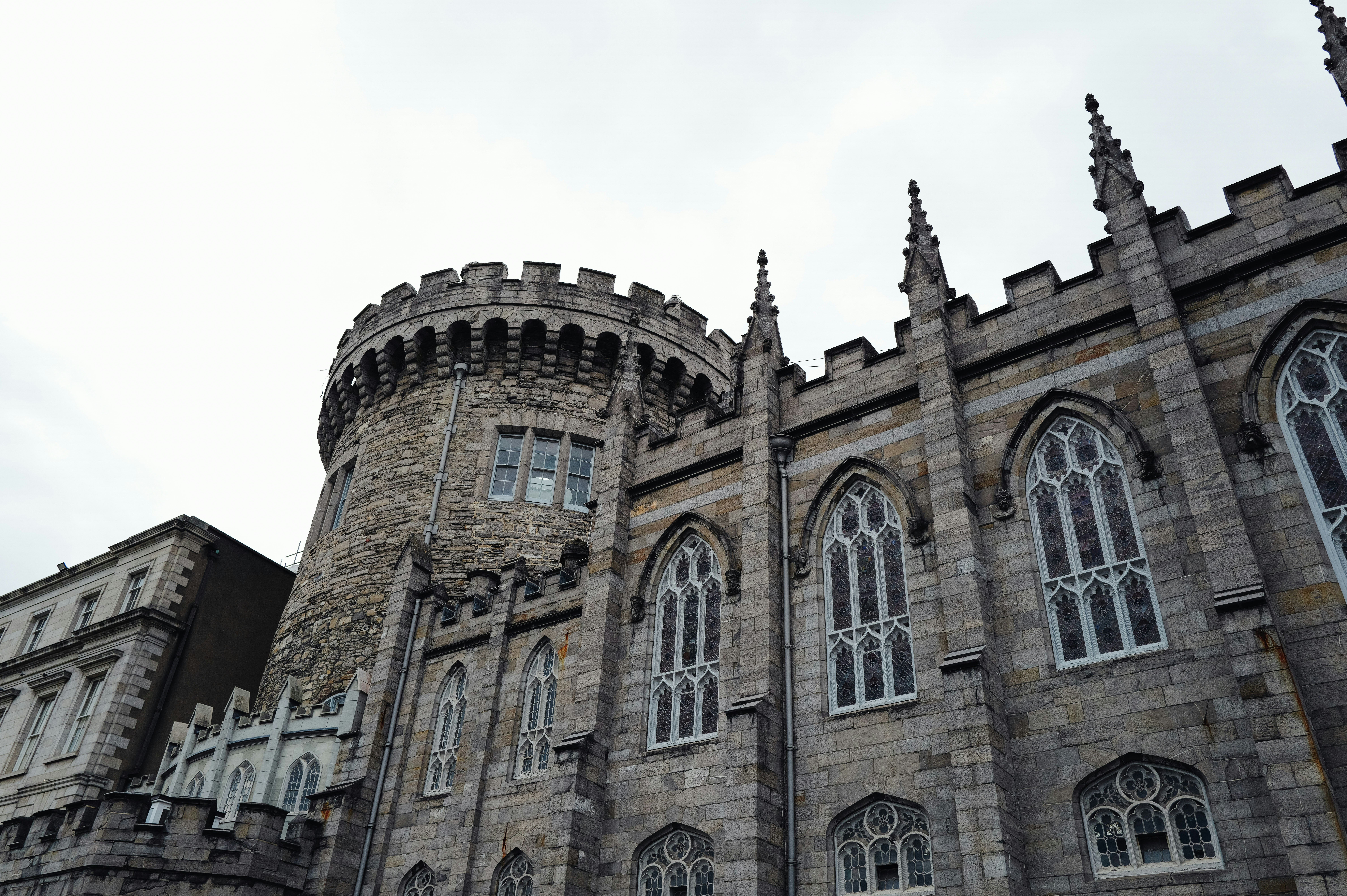 Historic stone castle with tall arched windows.