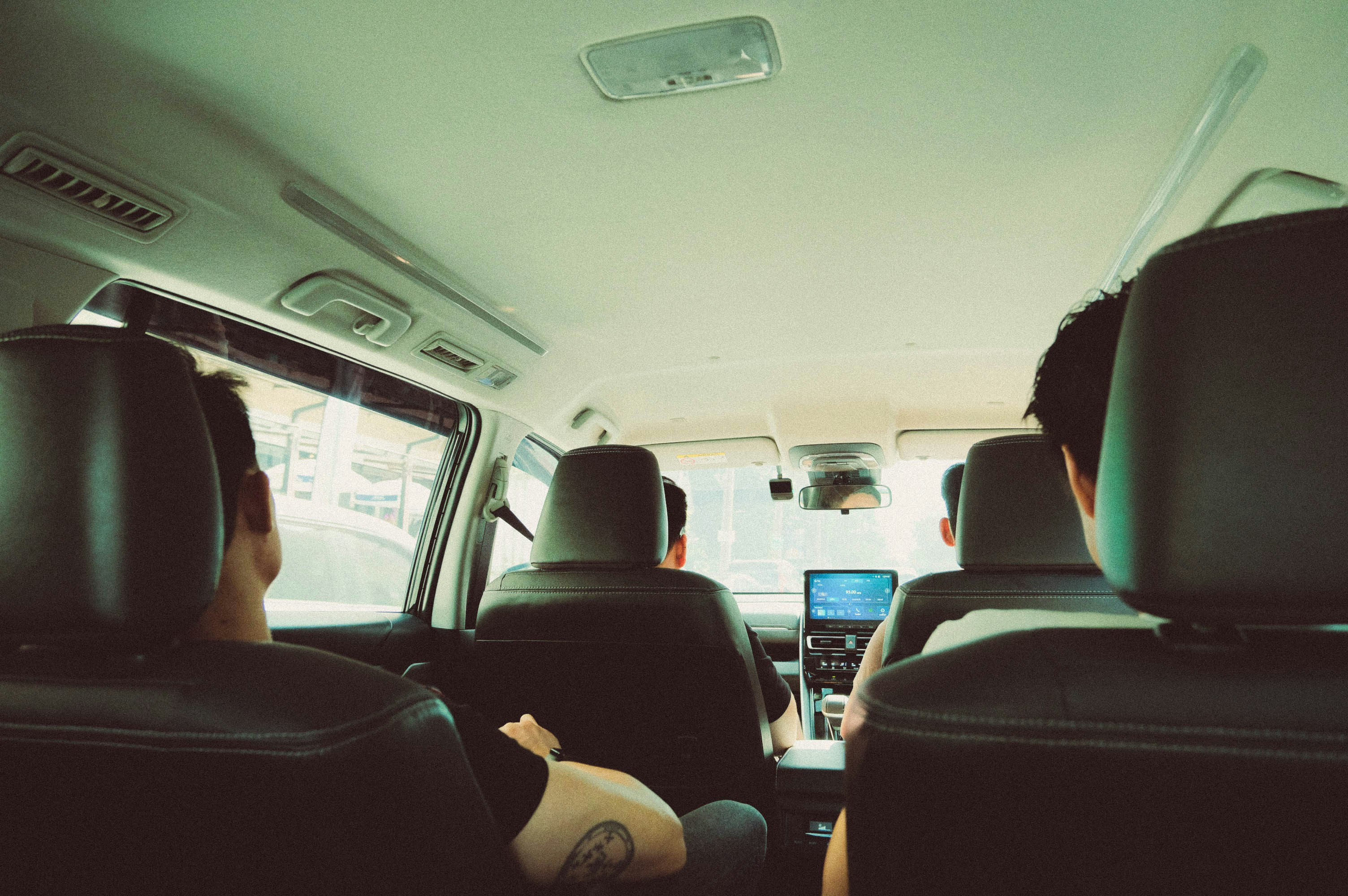 People riding in the back seat of a car.