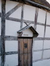 Timber-framed cottage with a wooden door.