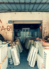 Many air conditioners are stored in an open shop.