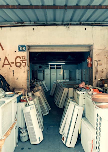 Many air conditioners are stored in an open shop.