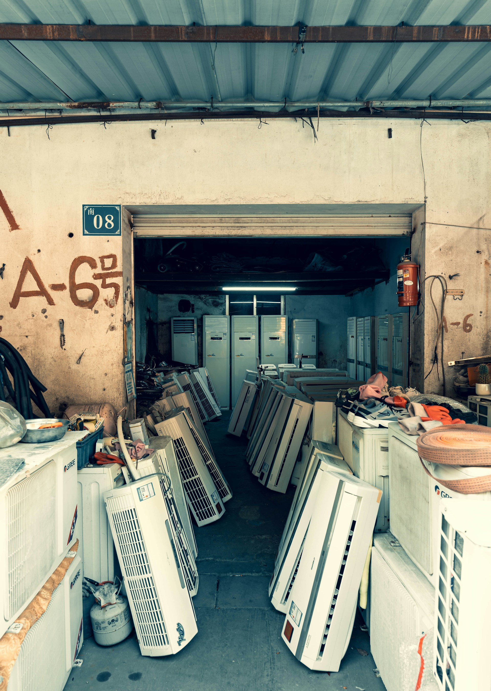 Many air conditioners are stored in an open shop.