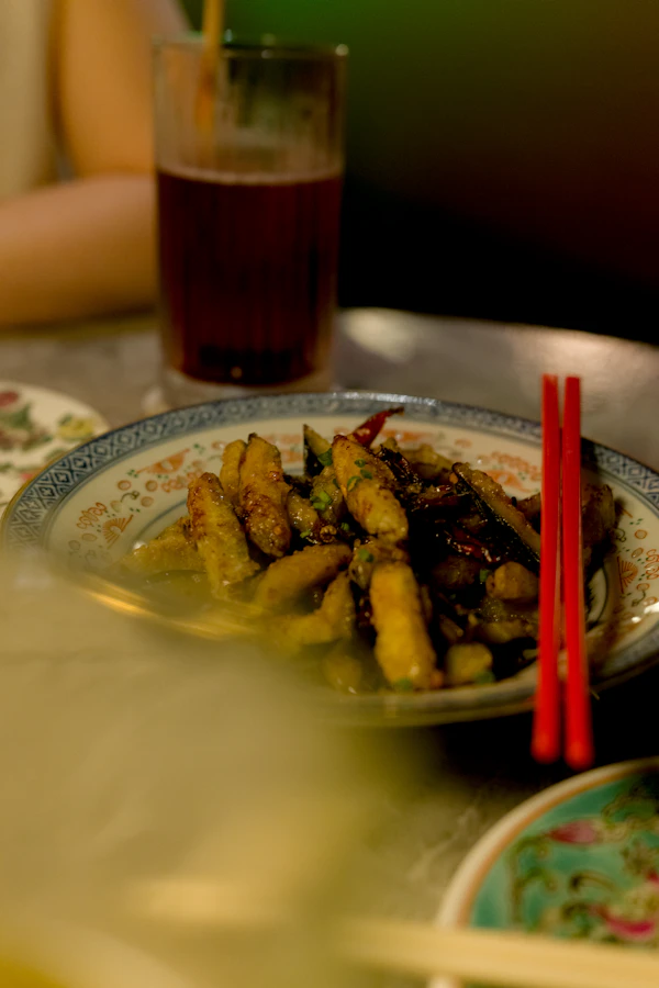 Fried eggplant with red chopsticks