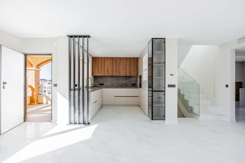 Modern kitchen with wooden cabinets and marble floors