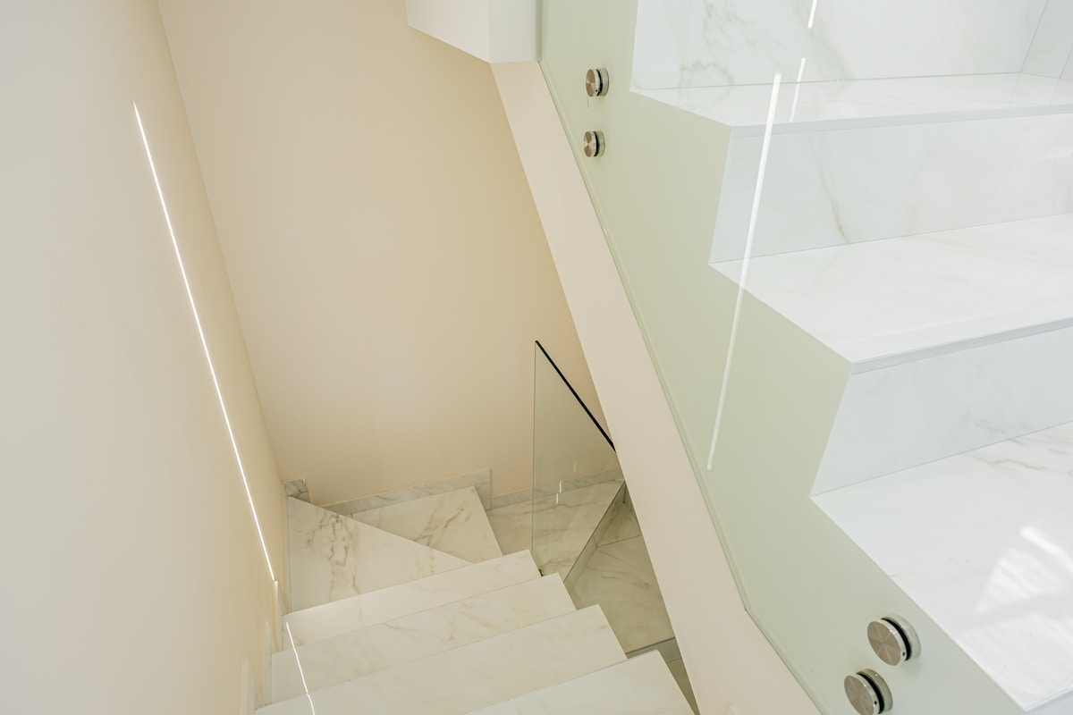 Modern white staircase with glass railing