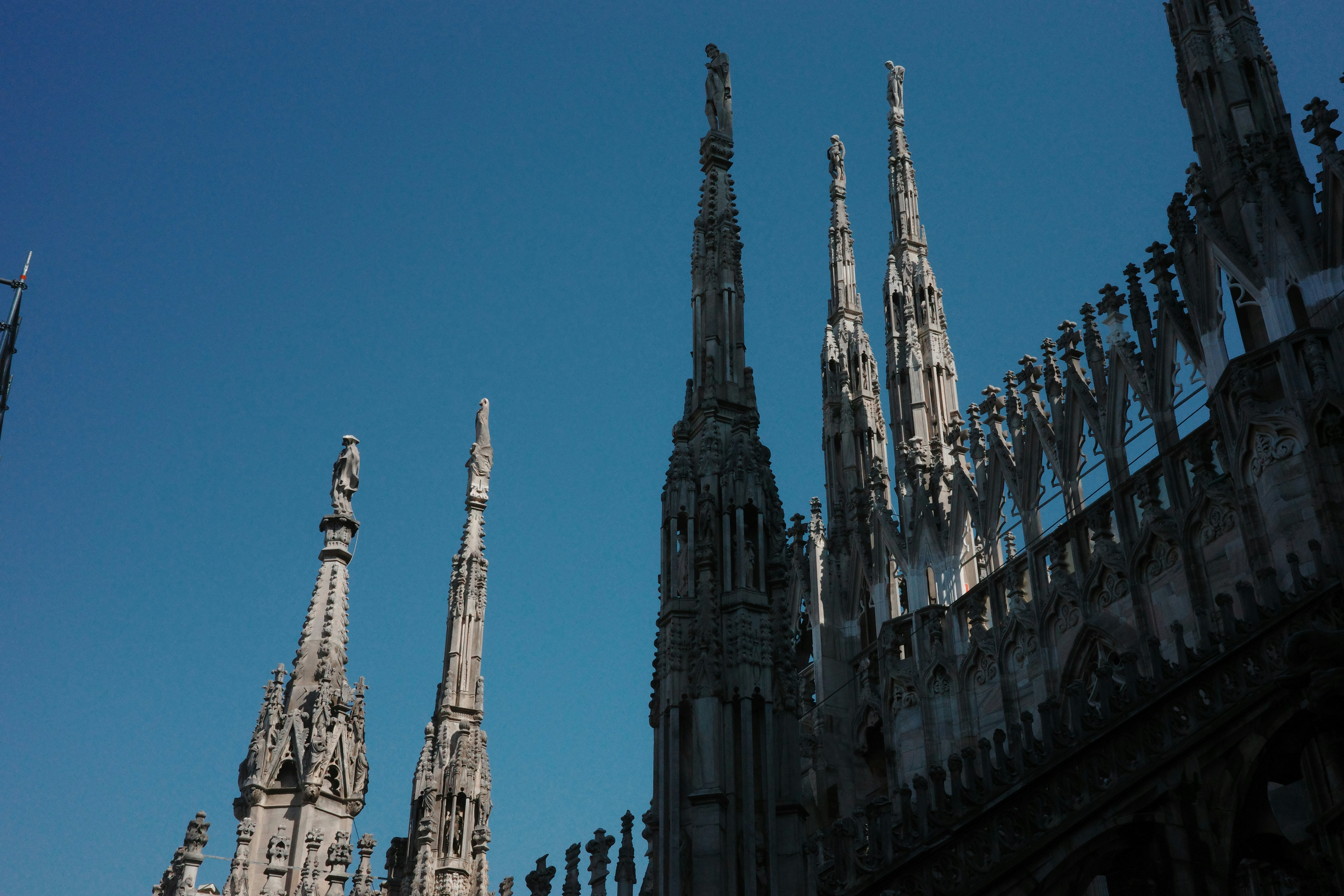 Gothic spires against a clear blue sky