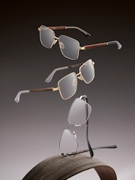 Three pairs of modern eyeglasses on a dark background.