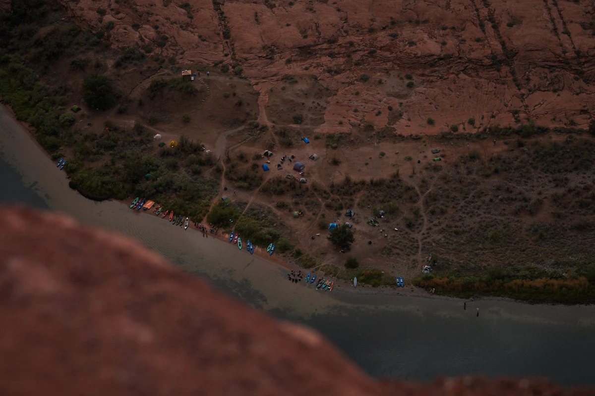 Overhead view of a riverbank campsite with tents