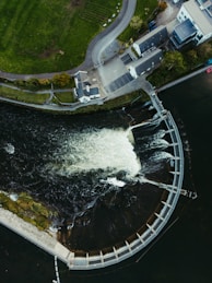 Aerial view of a dam with water flowing over it.