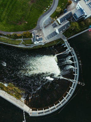 Aerial view of a dam with water flowing over it.