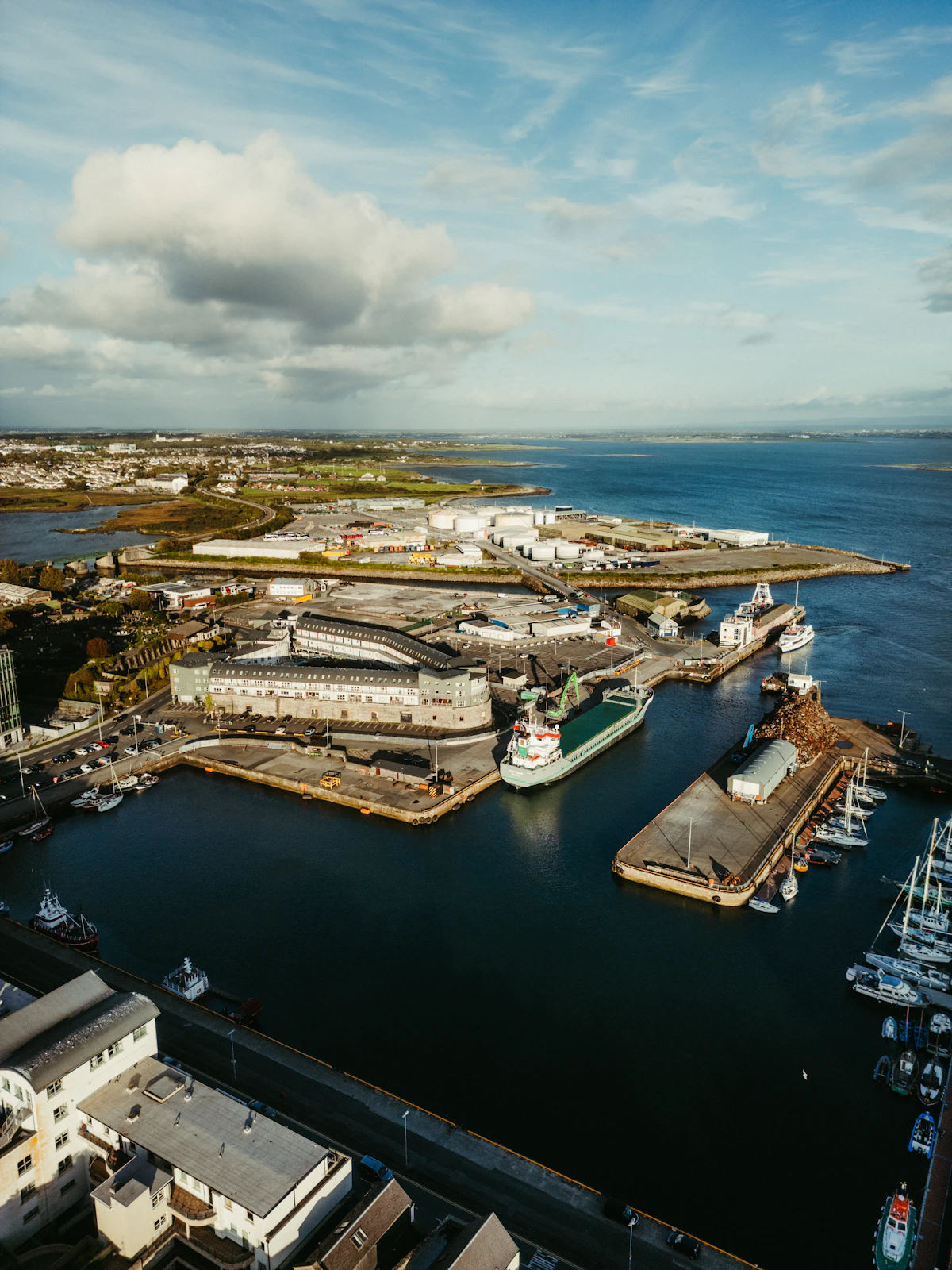 Aerial view of a busy harbor with cargo ships, representing global trade routes