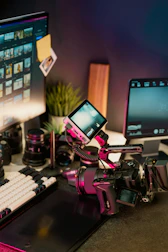 Filmmaker's desk with camera, lenses, and monitors