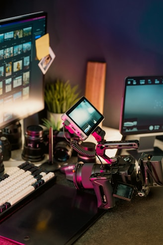 Filmmaker's desk with camera, lenses, and monitors