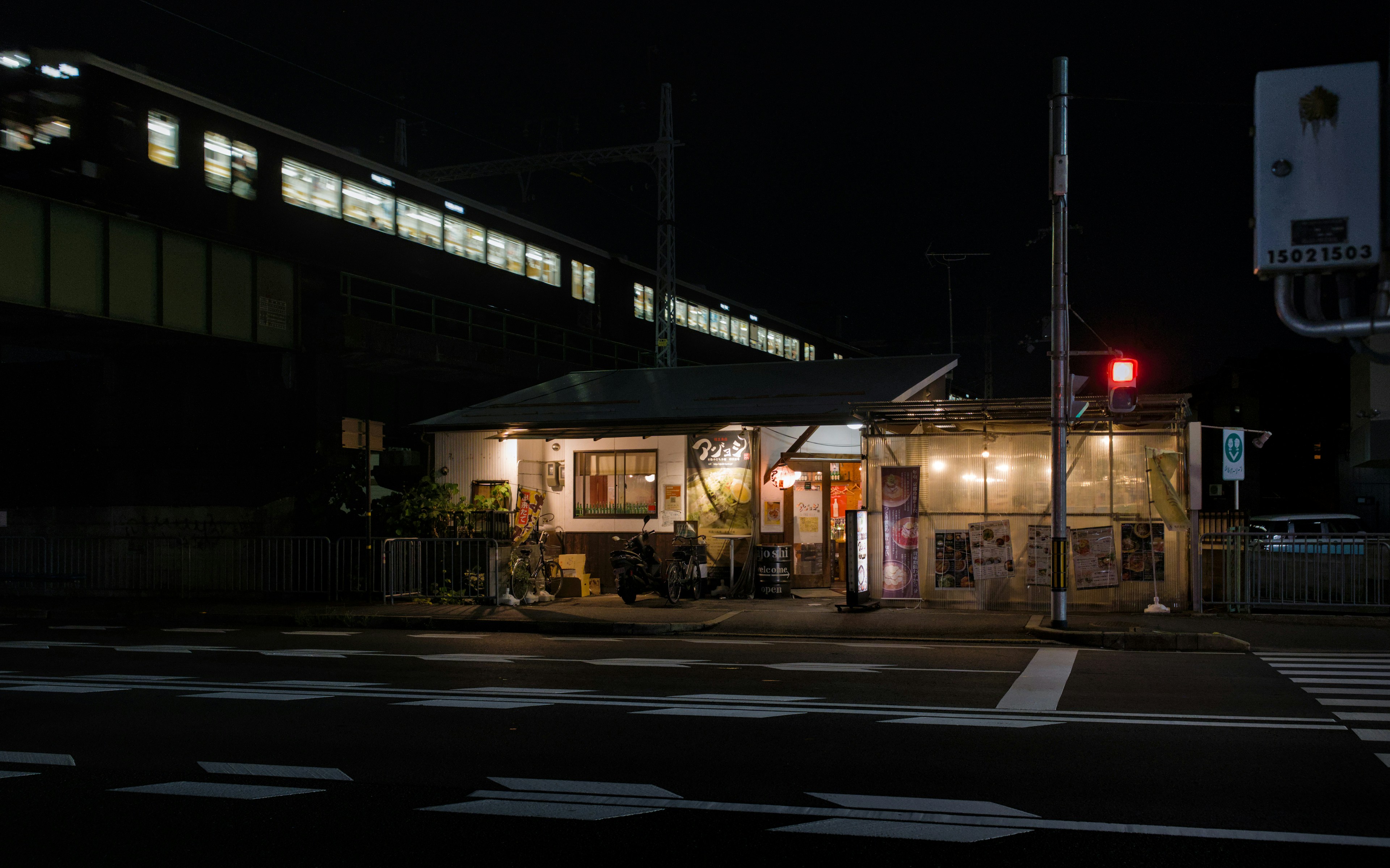 Vibrant Japanese train station area at night with restaurants