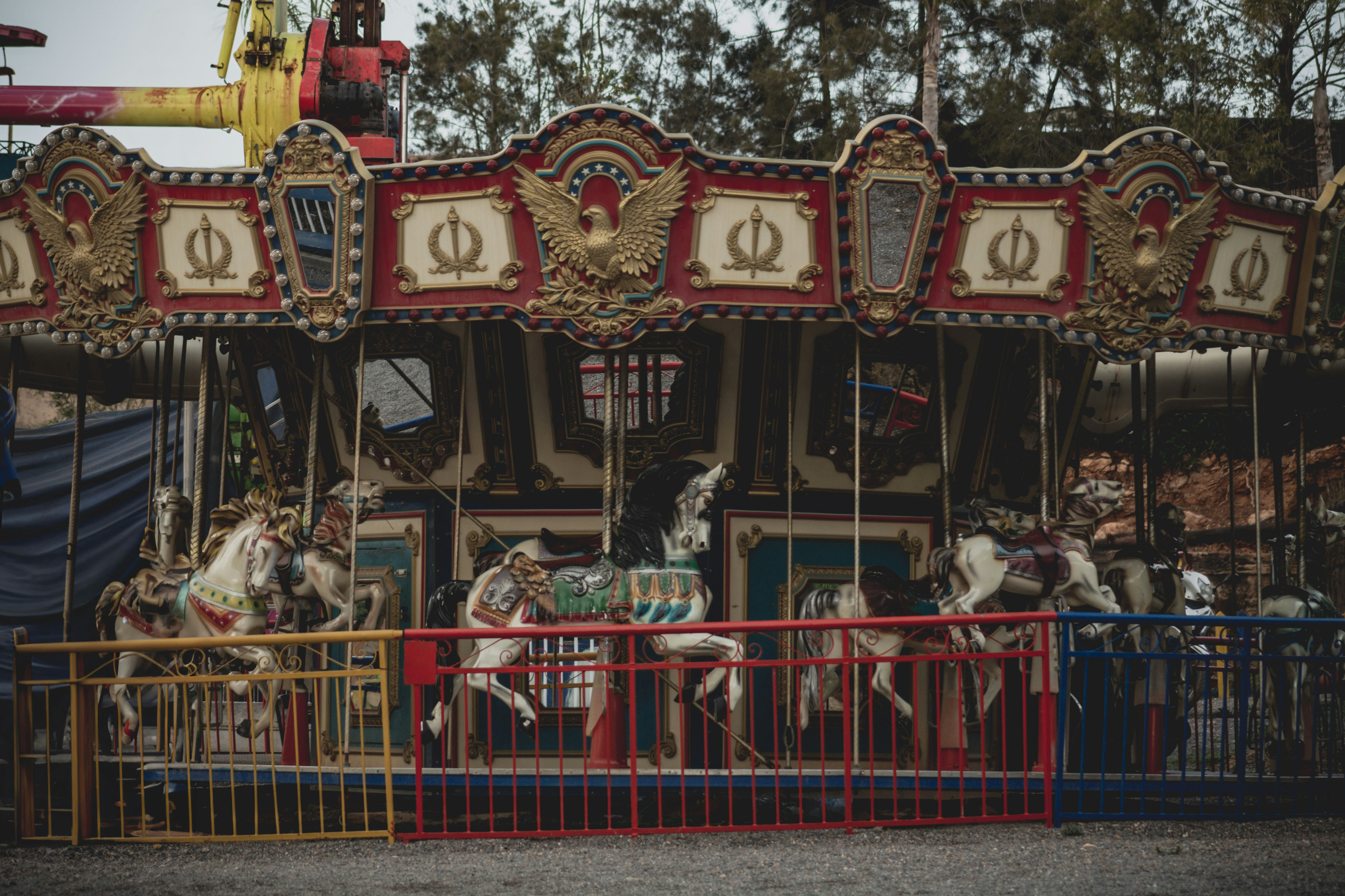 Ornate carousel with horses at an amusement park.