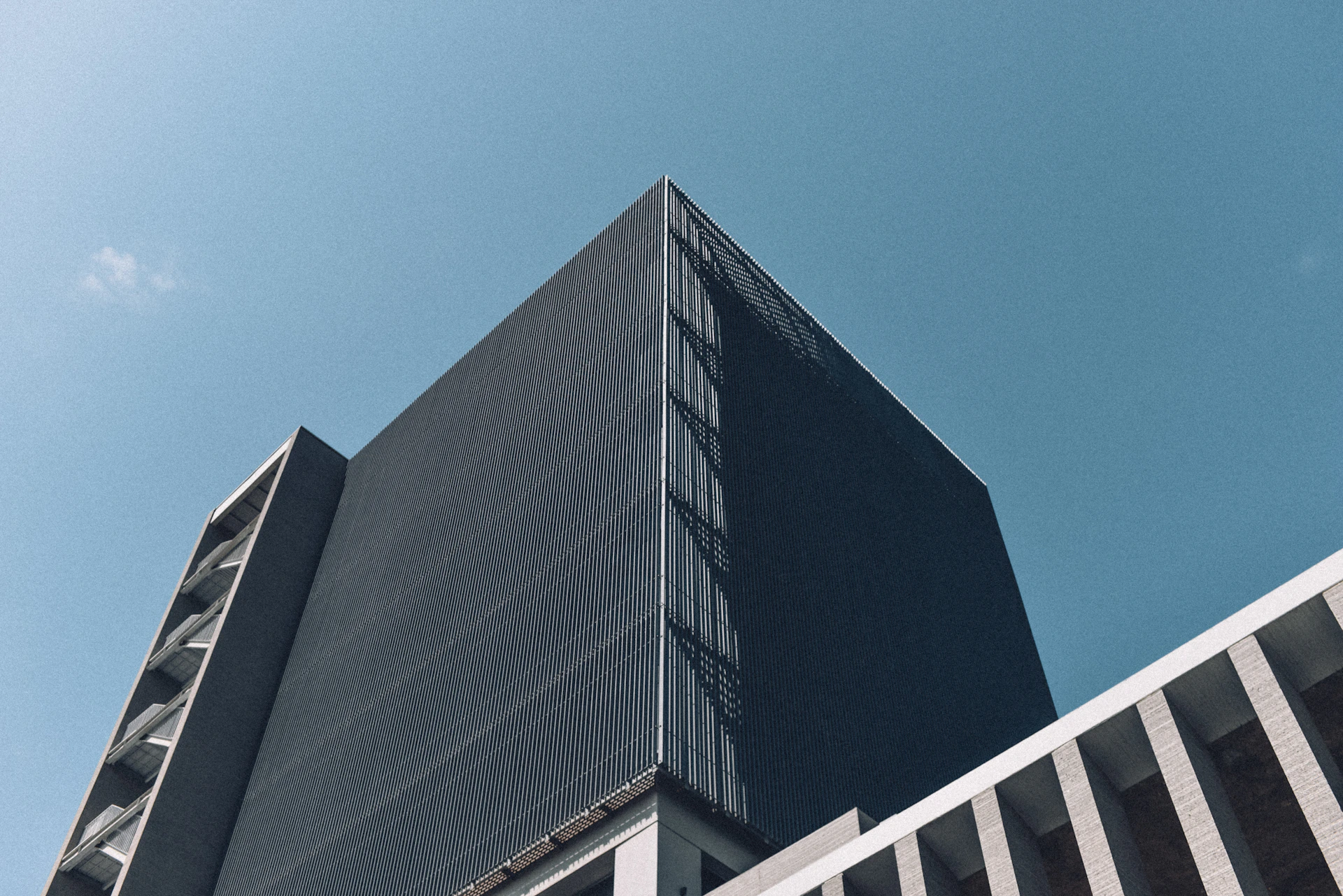 Modern dark building against a clear blue sky