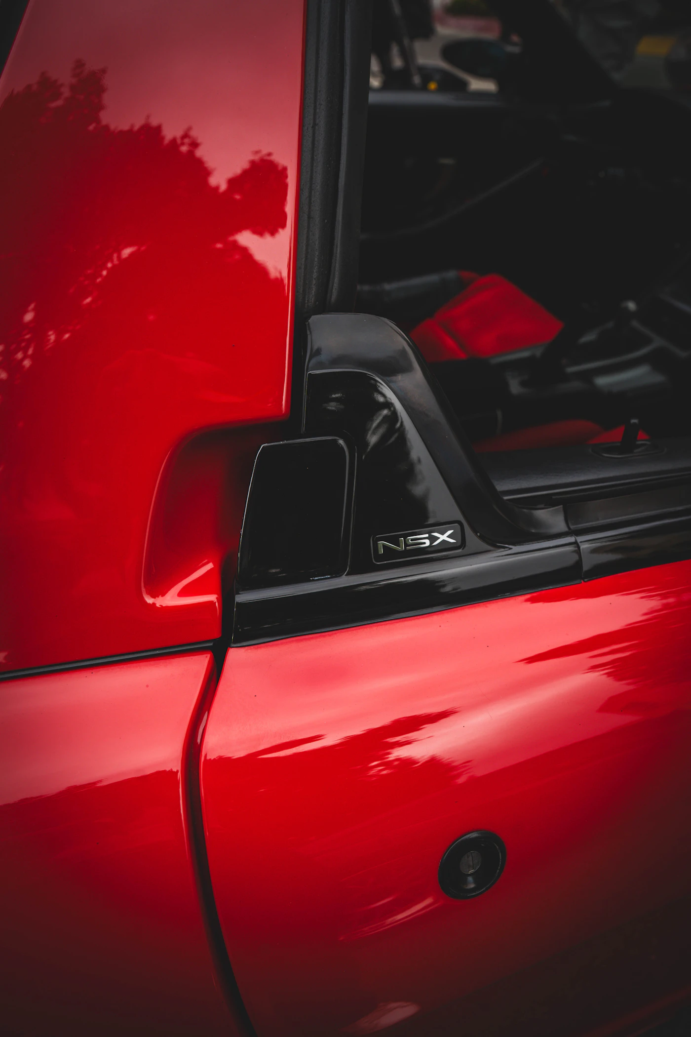 Red Acura NSX emblem close-up